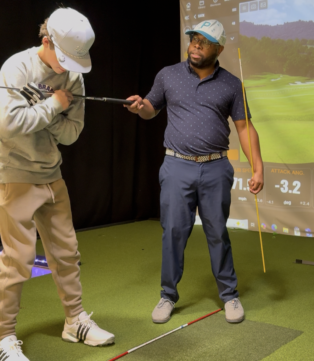 Coaching a junior golfer inside the simulator studio
